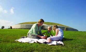 Family with newgrange in the background