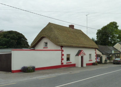 Photograph of a thatched house