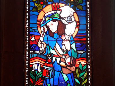 Photograph of stained glass window featuring a shepherd