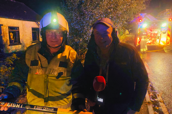 Firefighter speaking to a radio broadcaster