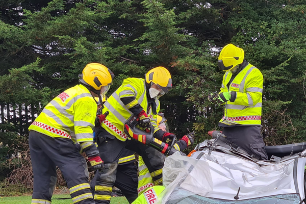 Firefighters cutting a car open