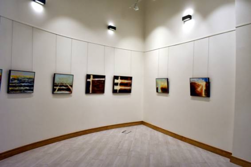 Photograph of art hanging on the wall of a gallery