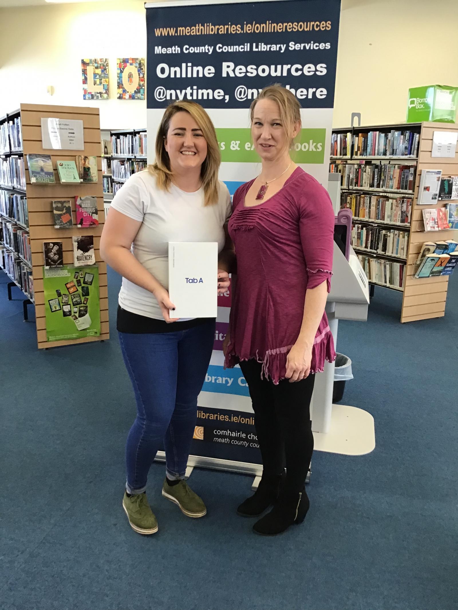 Winner Receiving Prize from Library Staff Member