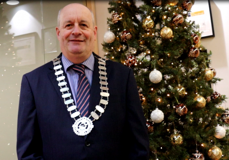 Cathaoirleach Cllr Sean Drew in front of Christmas Tree